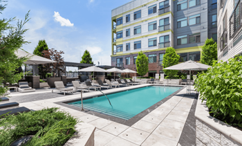 Resort-style outdoor pool with chaise lounges, sunning decks, ping-pong table and games